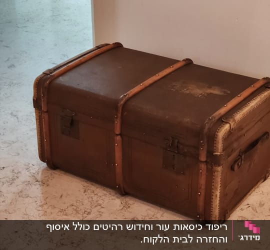 תיבה חומה עם רצועות עור על רצפה בהירה